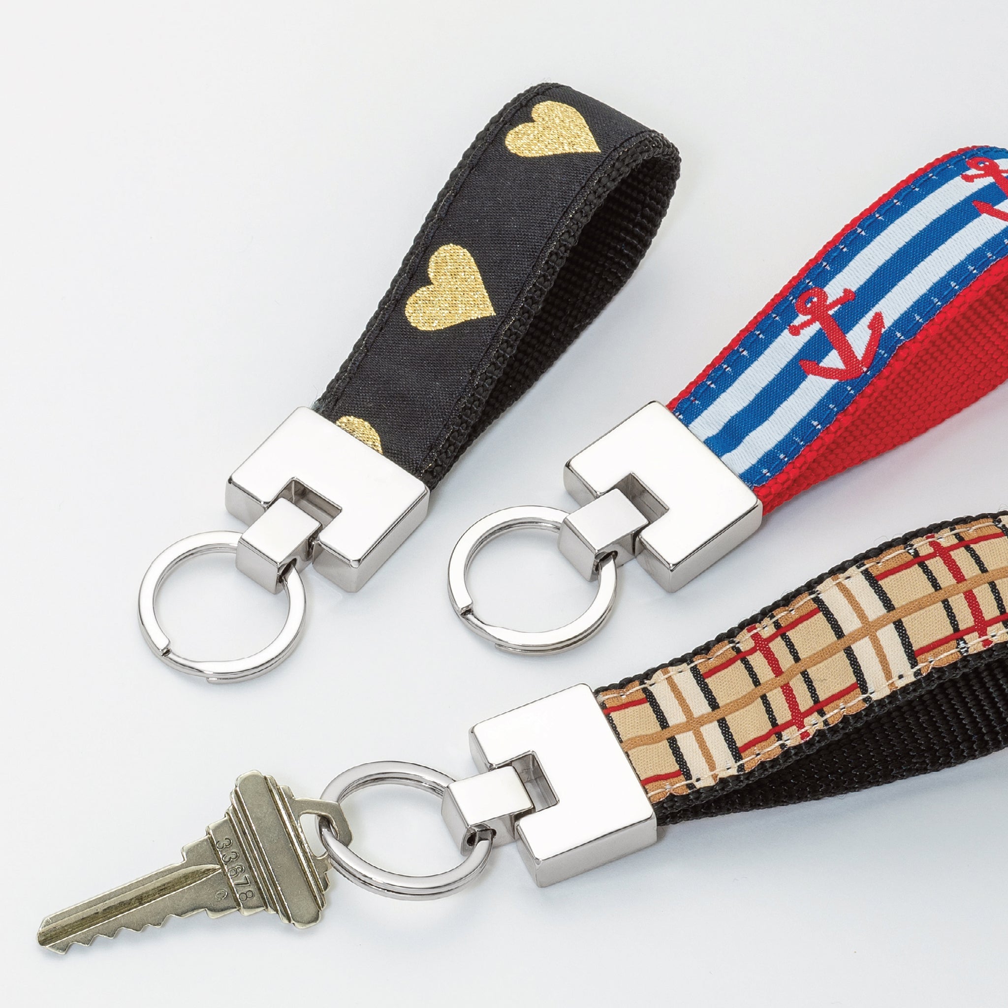 Three keychains with different designs on a white background