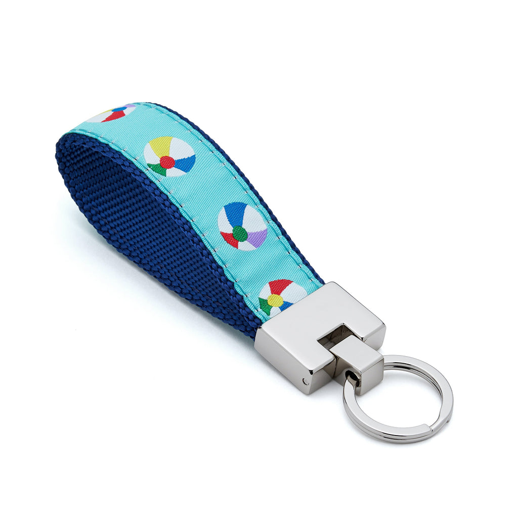 Keychain with colorful beach ball design on a blue strap against a white background