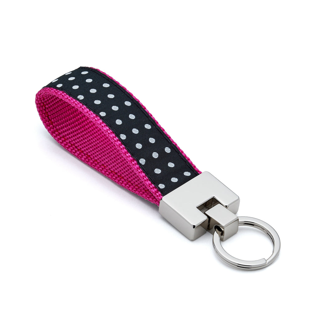 Keychain with pink and black polka dot strap on a white background