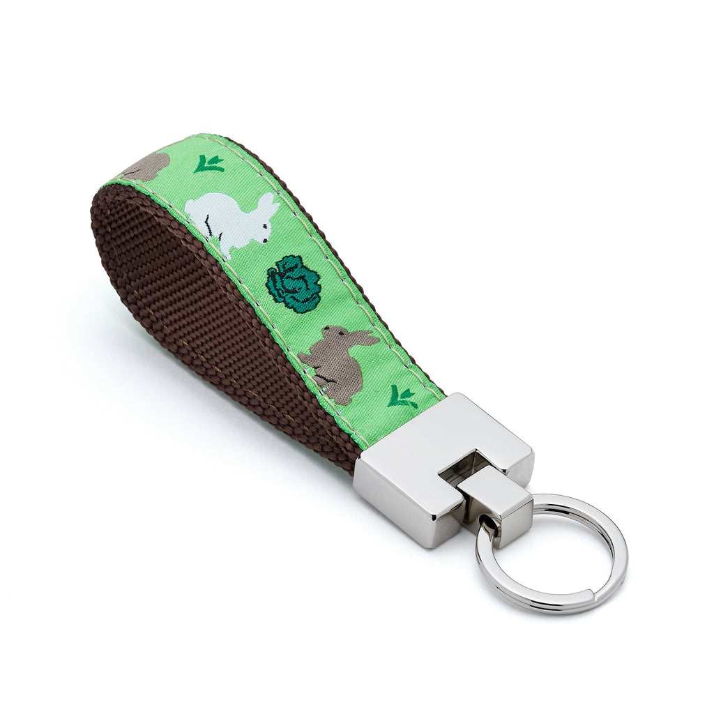 Keychain with a green strap featuring rabbit illustrations 