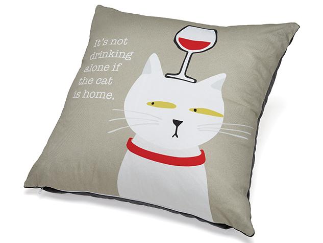 Pillow with a cat design and text on a beige background