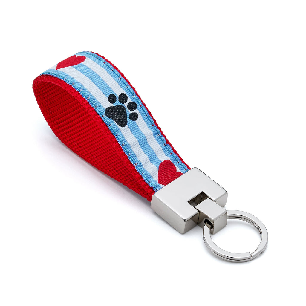 Keychain with red and blue striped strap featuring paw prints on a white background hearts puppy love