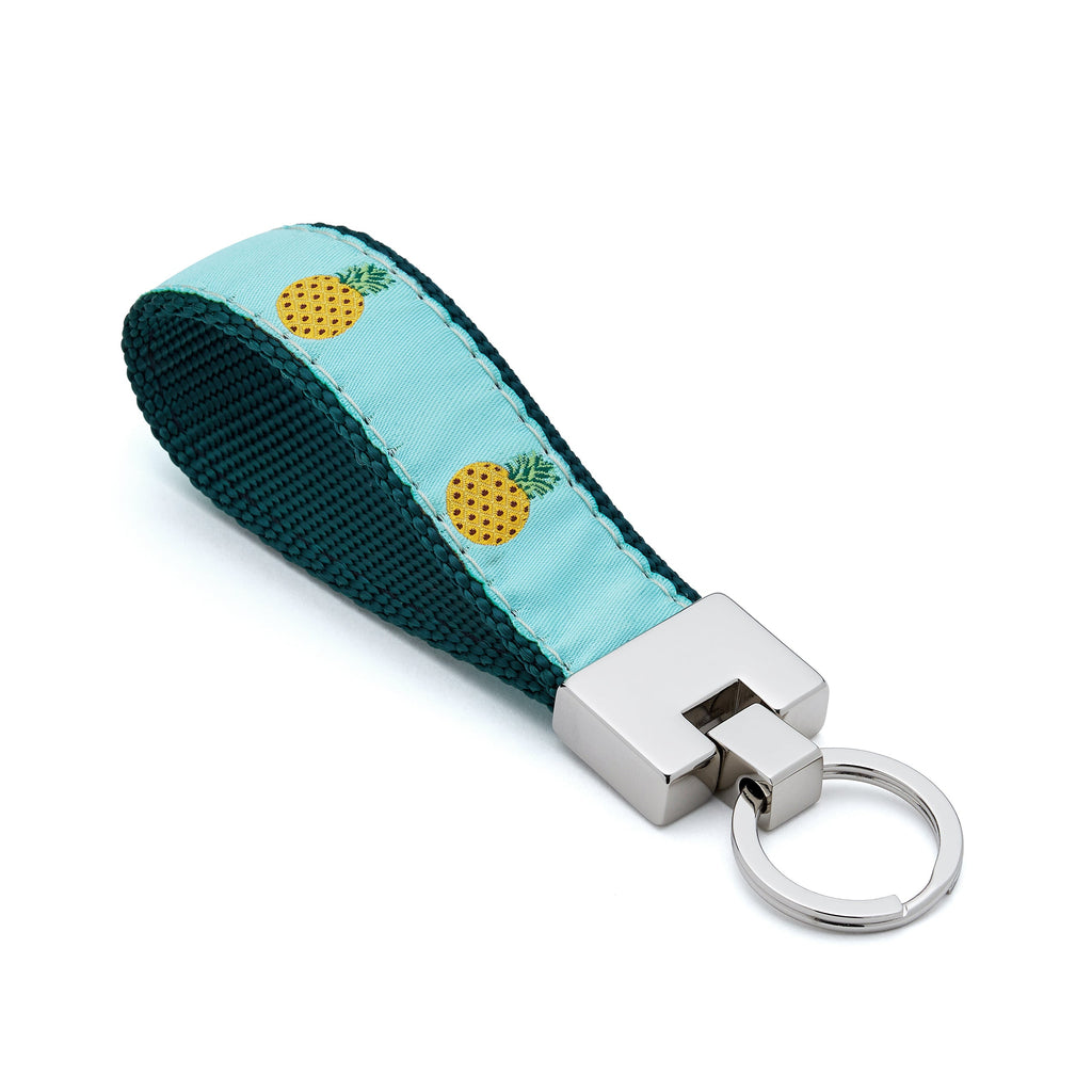 Keychain with pineapple design on a light blue strap against a white background