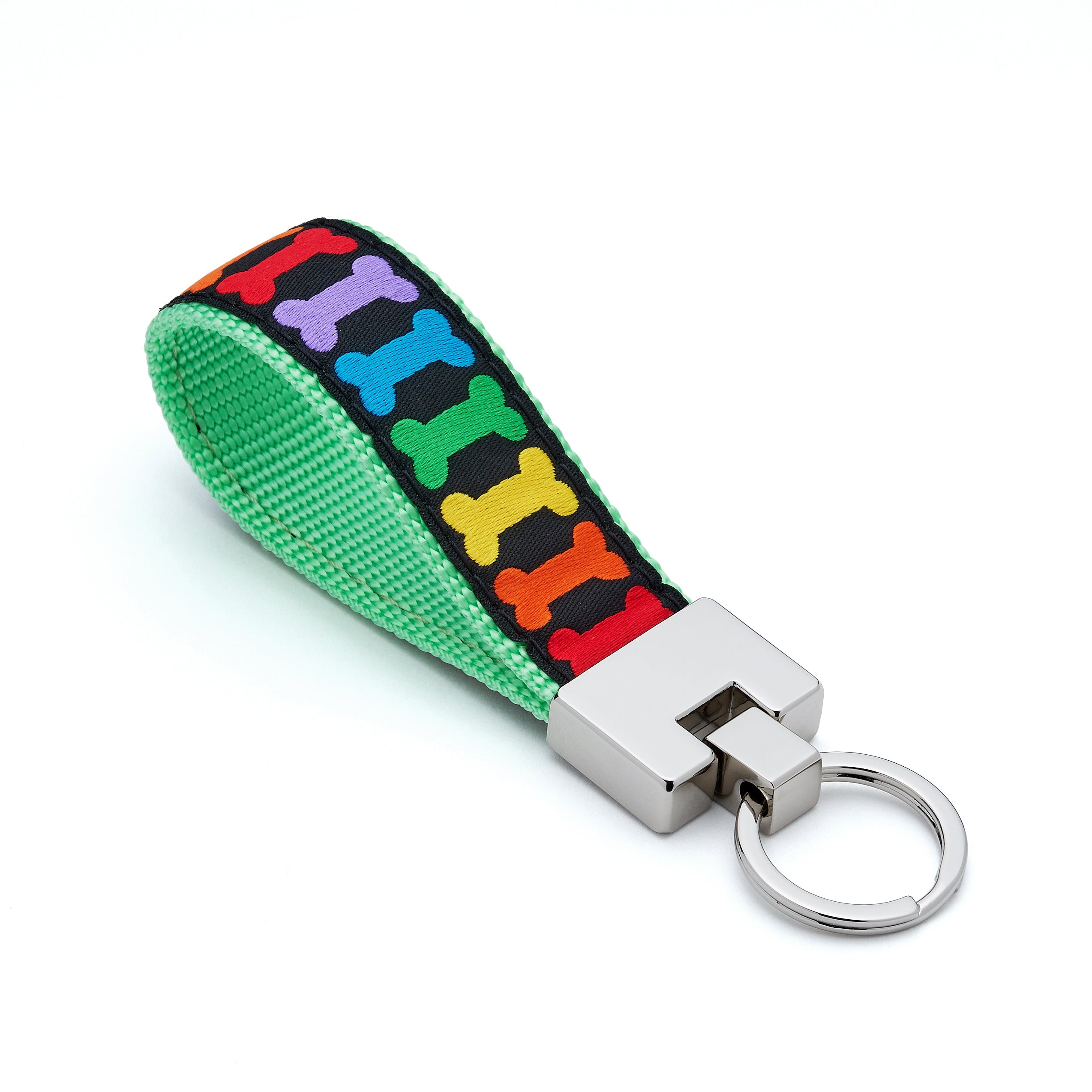 Keychain with colorful bone pattern on a green strap against a white background