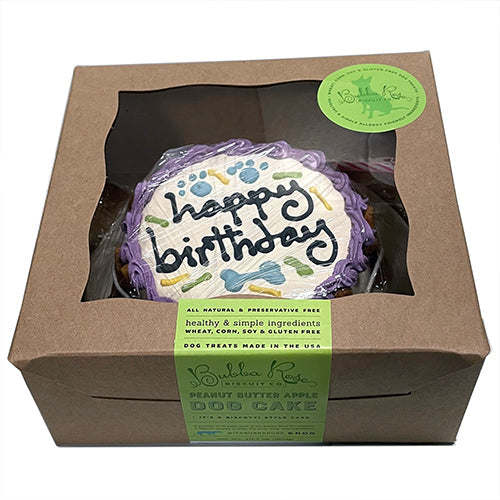 Dog birthday cake in a box with a visible brand label on a white background